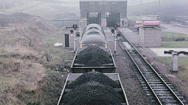 1980年，HA火车装载煤，沿着空轨道行驶，接近料斗屋/英国视频素材
